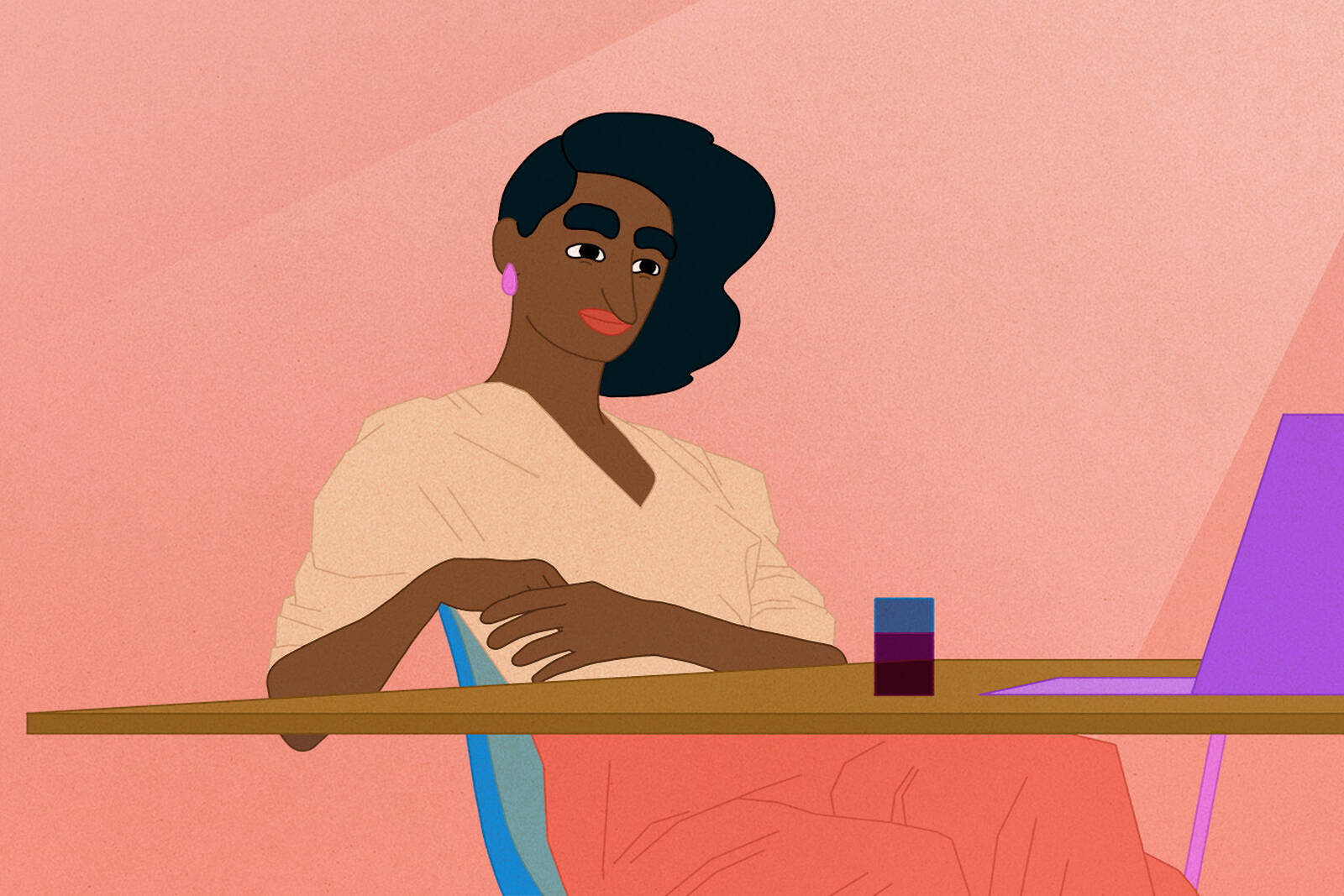 woman seated at desk looking at laptop